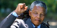 Nelson Mandela holds up his clenched fist in triumph the day after his release from prison in 1990 after 27 years at the age of 72. (Photo courtesy of Getty Images)